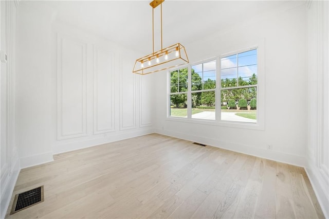 unfurnished dining area with light hardwood / wood-style flooring