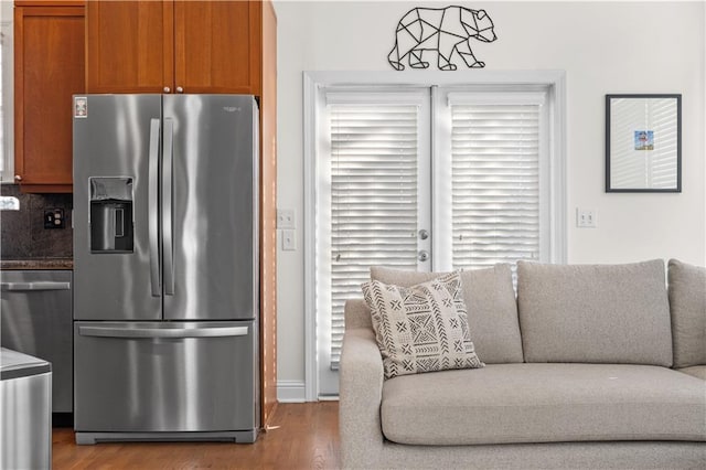 kitchen with hardwood / wood-style flooring, stainless steel refrigerator with ice dispenser, plenty of natural light, and backsplash