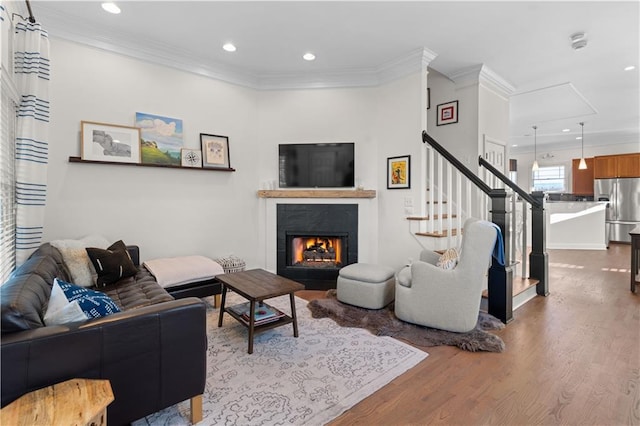 living room featuring hardwood / wood-style floors and crown molding