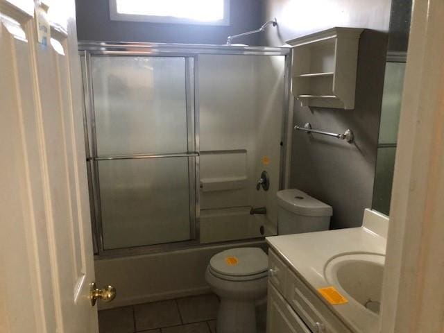 full bathroom with tile patterned floors, vanity, toilet, and combined bath / shower with glass door