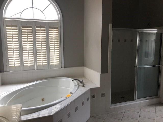 bathroom featuring plus walk in shower, tile patterned flooring, and vanity