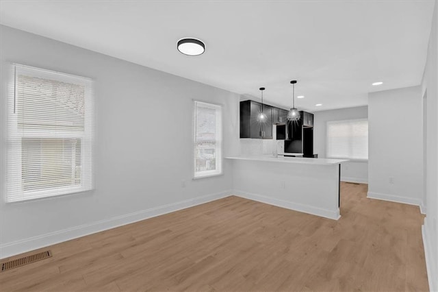 1222 E Forrest Ave, Atlanta, GA 30344 - unfurnished living room featuring baseboards, light wood-style floors, and recessed lighting