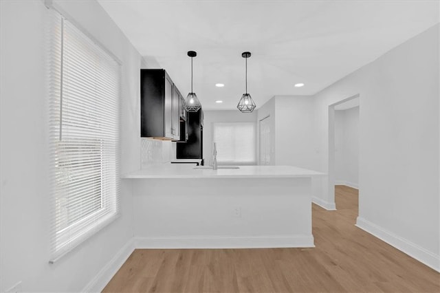 1222 E Forrest Ave, Atlanta, GA 30344 - kitchen with light countertops, a sink, baseboards, light wood-type flooring, and recessed lighting