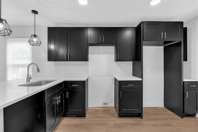 1222 E Forrest Ave, Atlanta, GA 30344 - kitchen with a sink, tasteful backsplash, light wood-type flooring, decorative light fixtures, and recessed lighting