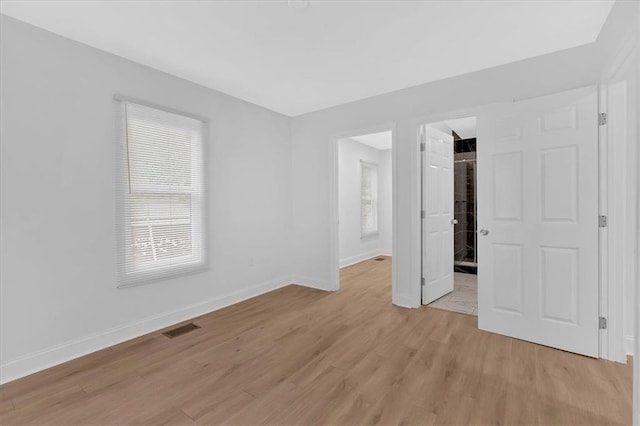 1222 E Forrest Ave, Atlanta, GA 30344 - unfurnished bedroom featuring light wood-style floors, baseboards, and a spacious closet