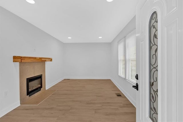1222 E Forrest Ave, Atlanta, GA 30344 - unfurnished living room featuring light wood-type flooring, baseboards, a fireplace, and recessed lighting