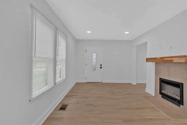 1222 E Forrest Ave, Atlanta, GA 30344 - foyer entrance featuring a fireplace, baseboards, light wood-type flooring, and recessed lighting