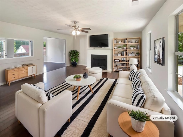 727 Overlook Crst, Monroe, GA 30655 - living area with wood finished floors, a ceiling fan, a fireplace with flush hearth, and baseboards