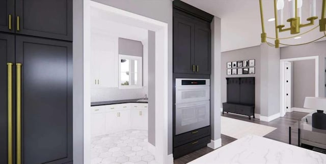 0 Wynn Dr, Carrollton, GA 30117 - kitchen with double oven, baseboards, paneled refrigerator, tasteful backsplash, and dark wood-style flooring