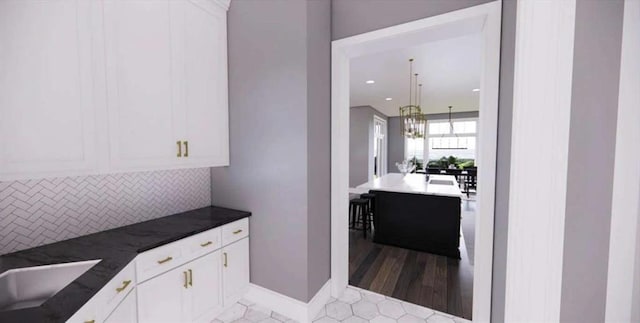 0 Wynn Dr, Carrollton, GA 30117 - kitchen with decorative backsplash, white cabinetry, a sink, and dark countertops