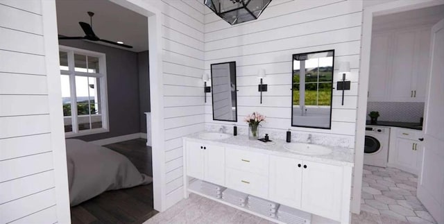 0 Wynn Dr, Carrollton, GA 30117 - full bath featuring washer / dryer, double vanity, and wooden walls