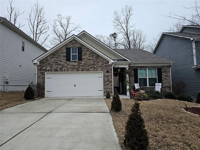 craftsman-style home featuring a garage, driveway, brick siding, and roof with shingles