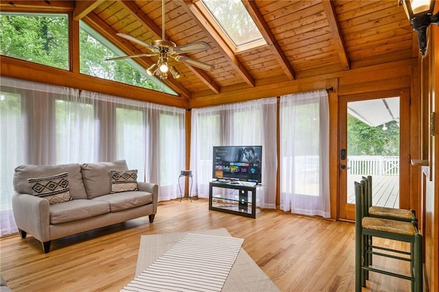 living area featuring wood ceiling, a ceiling fan, light wood finished floors, and a healthy amount of sunlight