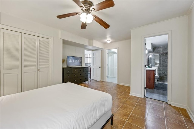 tiled bedroom featuring a closet, connected bathroom, a ceiling fan, and baseboards