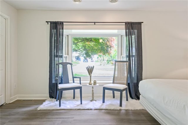 bedroom featuring visible vents, wood finished floors, and baseboards