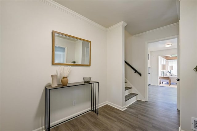 corridor featuring stairs, dark wood-style floors, baseboards, and ornamental molding