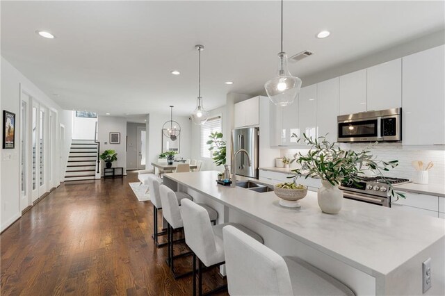 205 Wilbur Ave SE Unit A, Atlanta, GA 30316 - kitchen with light countertops, visible vents, a kitchen island with sink, appliances with stainless steel finishes, and white cabinetry