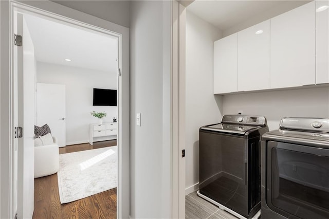 205 Wilbur Ave SE Unit A, Atlanta, GA 30316 - clothes washing area with washing machine and clothes dryer, cabinet space, dark wood-style flooring, and baseboards