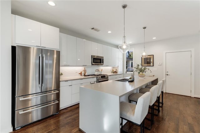 205 Wilbur Ave SE Unit A, Atlanta, GA 30316 - kitchen featuring stainless steel appliances, a kitchen breakfast bar, a sink, visible vents, and backsplash