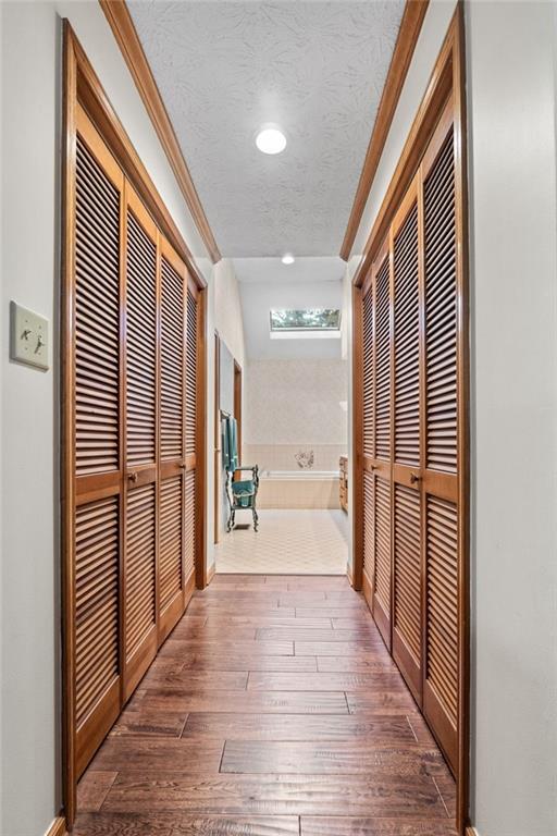 110 The Farm Rd, Mcdonough, GA 30252 - hallway with crown molding, recessed lighting, a textured ceiling, and hardwood / wood-style flooring