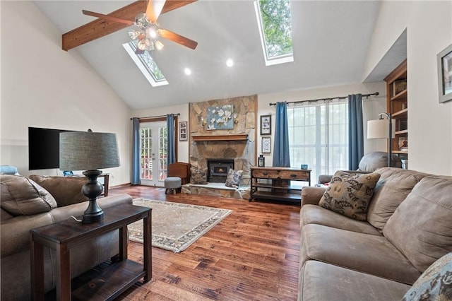 110 The Farm Rd, Mcdonough, GA 30252 - living room featuring wood finished floors, beamed ceiling, high vaulted ceiling, a ceiling fan, and a skylight