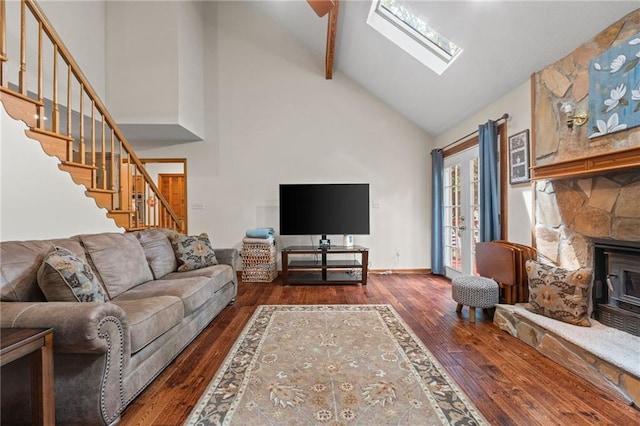 110 The Farm Rd, Mcdonough, GA 30252 - living room with dark wood-style flooring, high vaulted ceiling, a stone fireplace, a skylight, and stairway