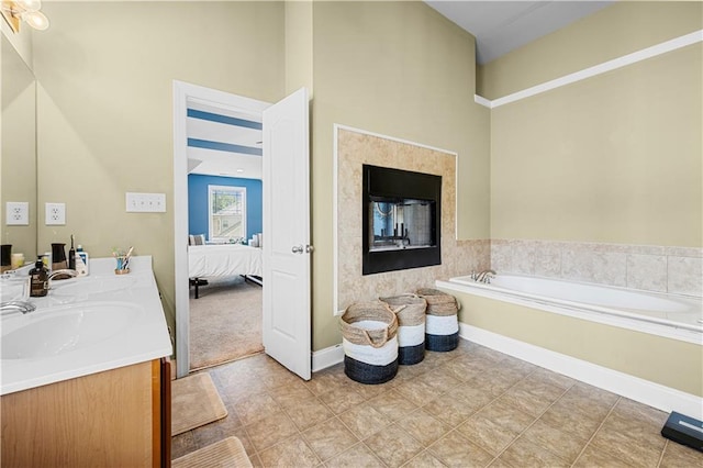 240 Daisy Cir, Mcdonough, GA 30252 - ensuite bathroom featuring double vanity, a bath, a high ceiling, tile patterned floors, and a fireplace