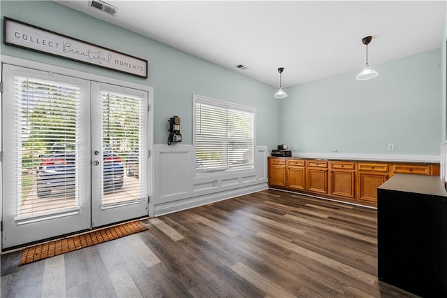 240 Daisy Cir, Mcdonough, GA 30252 - interior space featuring dark wood-type flooring, hanging light fixtures, wainscoting, and french doors