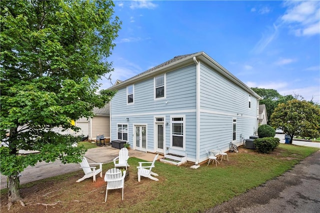 240 Daisy Cir, Mcdonough, GA 30252 - back of house with french doors, a lawn, and a patio area