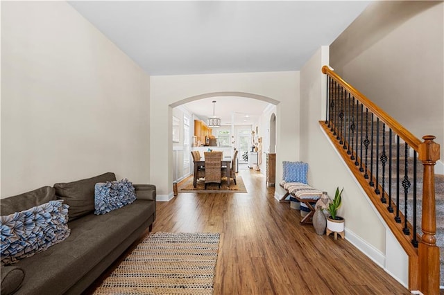 240 Daisy Cir, Mcdonough, GA 30252 - living area with arched walkways, wood finished floors, and stairs