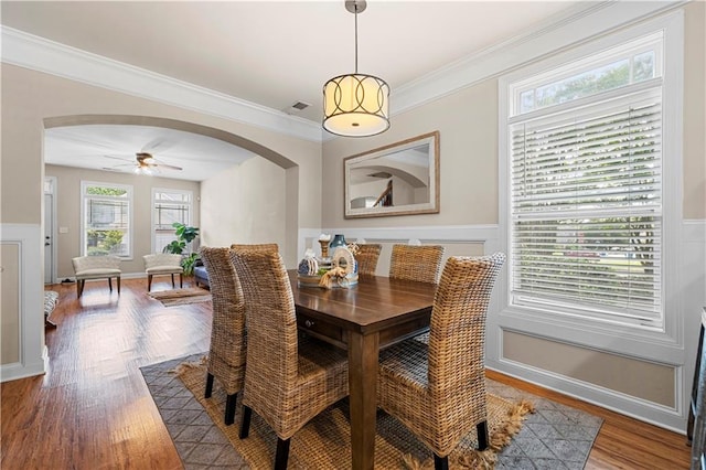 240 Daisy Cir, Mcdonough, GA 30252 - dining room featuring arched walkways, wood finished floors, a wainscoted wall, ornamental molding, and a ceiling fan