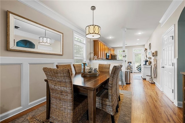 240 Daisy Cir, Mcdonough, GA 30252 - dining room with light wood-style floors, crown molding, recessed lighting, and a decorative wall