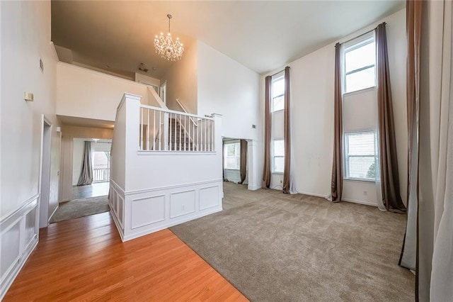 5280 Lakerock Way S, Fulton, GA 30331 - foyer entrance featuring a chandelier, a high ceiling, light wood-style floors, a decorative wall, and stairs