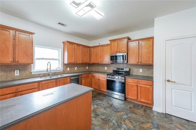 5280 Lakerock Way S, Fulton, GA 30331 - kitchen featuring appliances with stainless steel finishes, brown cabinetry, tasteful backsplash, and stone finish floors