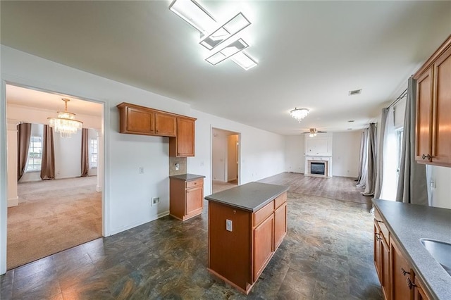 5280 Lakerock Way S, Fulton, GA 30331 - kitchen featuring dark countertops, brown cabinets, a chandelier, open floor plan, and a center island