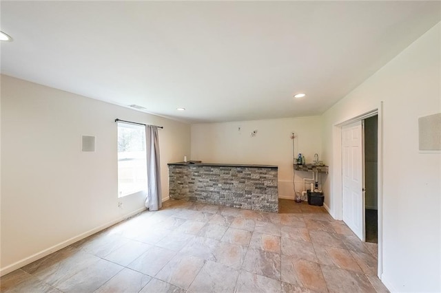 5280 Lakerock Way S, Fulton, GA 30331 - unfurnished living room with recessed lighting and light stone finish flooring