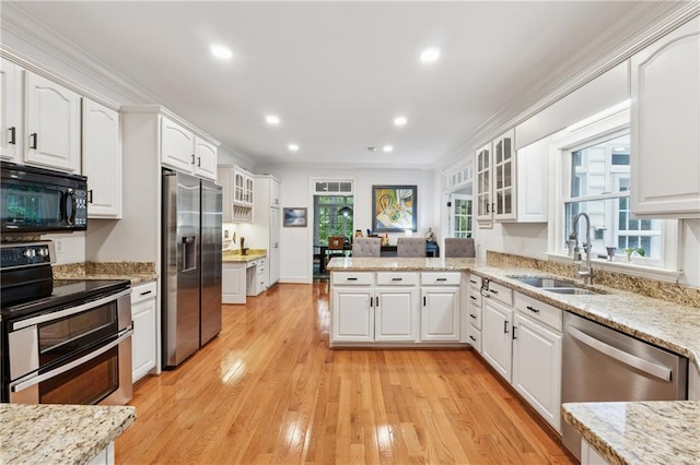 34 Johnston Row NW, Cartersville, GA 30121 - kitchen featuring stainless steel appliances, ornamental molding, white cabinetry, a peninsula, and glass insert cabinets