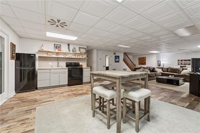 34 Johnston Row NW, Cartersville, GA 30121 - dining area with light wood finished floors, wet bar, and stairway