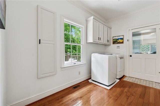 34 Johnston Row NW, Cartersville, GA 30121 - washroom featuring independent washer and dryer, light wood-style floors, crown molding, and cabinet space