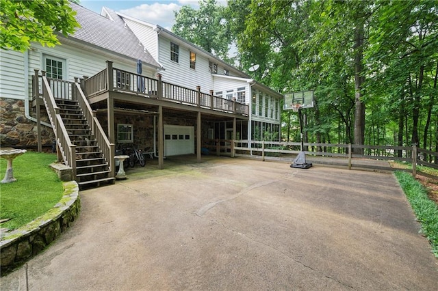 34 Johnston Row NW, Cartersville, GA 30121 - back of property featuring a garage, a deck, concrete driveway, and stairs