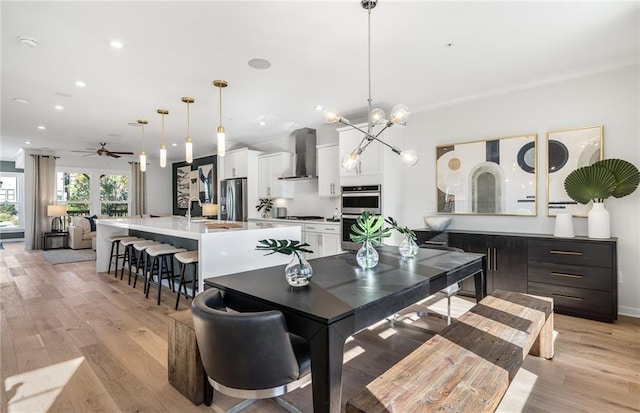 1105 Rivard Cir NW, Atlanta, GA 30318 - dining space with ceiling fan, light wood-type flooring, recessed lighting, a chandelier, and ornamental molding