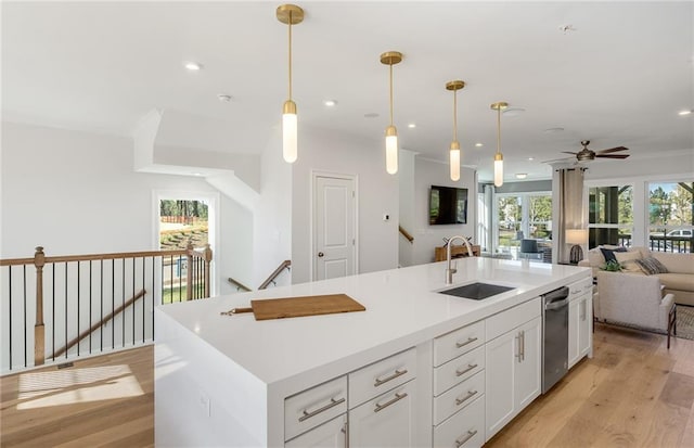 1105 Rivard Cir NW, Atlanta, GA 30318 - kitchen with a sink, open floor plan, a ceiling fan, light wood finished floors, and white cabinetry