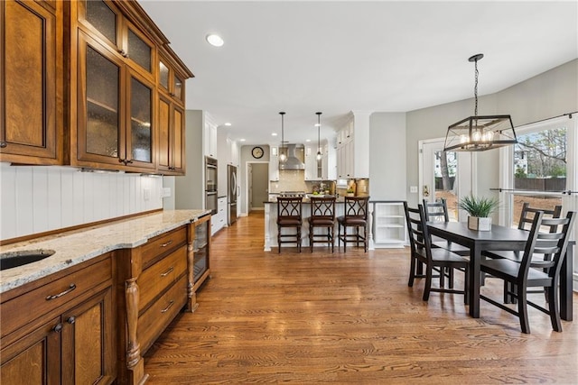 dining room featuring recessed lighting, dark wood finished floors, and an inviting chandelier