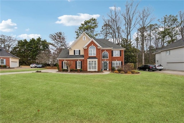 view of front facade with brick siding and a front yard