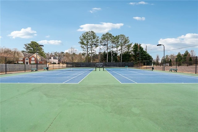 view of tennis court featuring fence