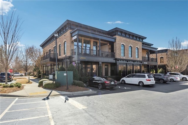 view of building exterior featuring uncovered parking