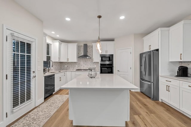 1547 Trilogy Park, Hoschton, GA 30548 - kitchen featuring black appliances, wall chimney range hood, a sink, white cabinetry, and light countertops