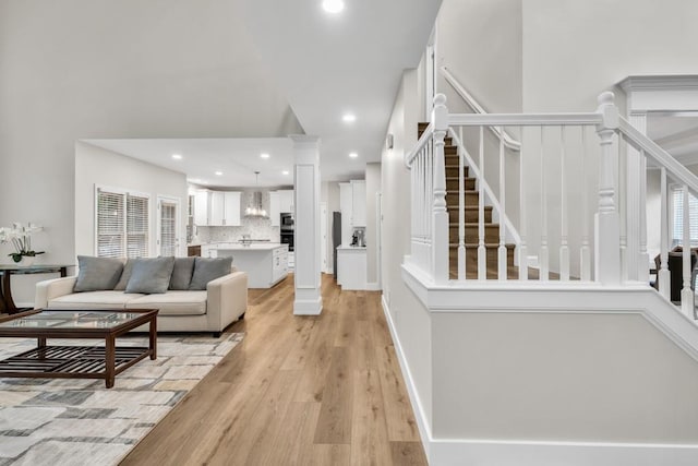 1547 Trilogy Park, Hoschton, GA 30548 - living area featuring stairs, light wood-type flooring, recessed lighting, and ornate columns