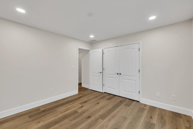 1547 Trilogy Park, Hoschton, GA 30548 - unfurnished bedroom featuring baseboards, light wood-style flooring, recessed lighting, and a closet
