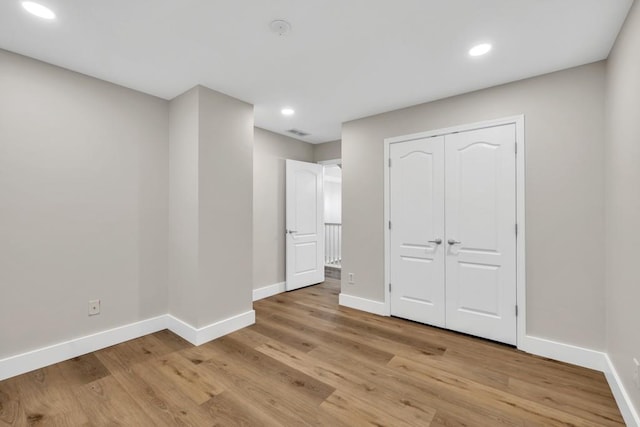 1547 Trilogy Park, Hoschton, GA 30548 - unfurnished bedroom with baseboards, light wood-style flooring, recessed lighting, and a closet